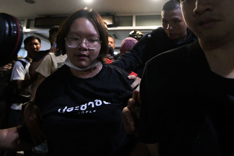 Student leader Panusaya "Rung" Sithijirawattanakul walks outside the Prachachuen police station in Bangkok