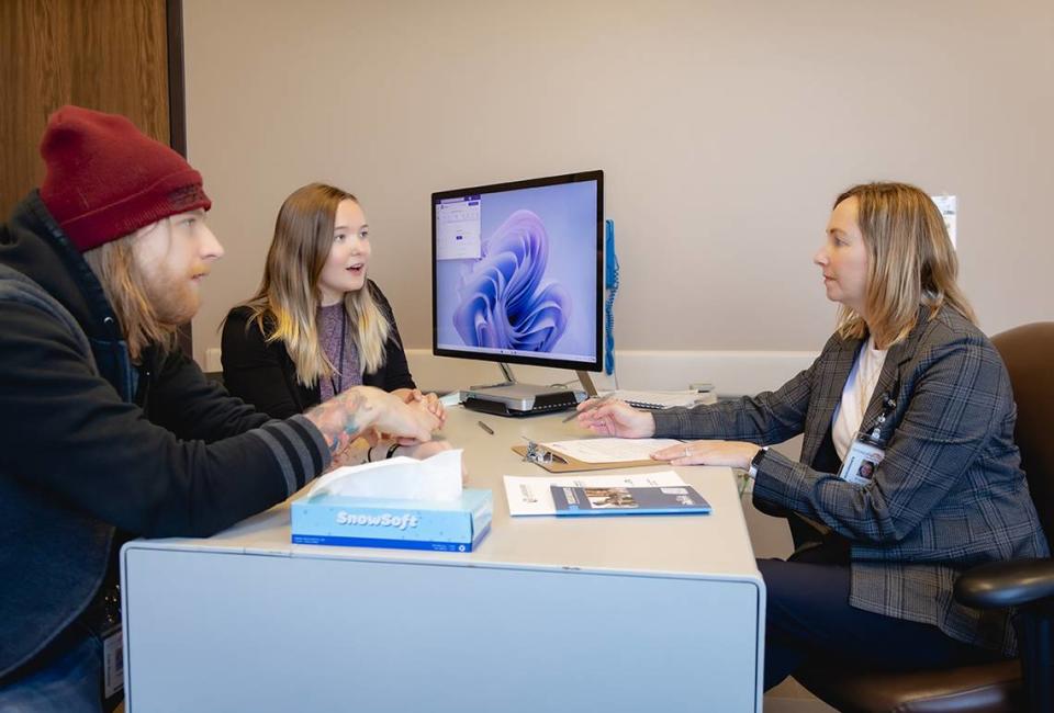 Kristen Spykerman, right, chief clinical officer for Network 180, meets with Taylor Beals, mobile crisis response clinician, and Mariekie Barone, a mobile crisis response manager. The county mental health authority, Network 180 is a lead agency helping spearhead collaboration in Grand Rapids, Michigan.