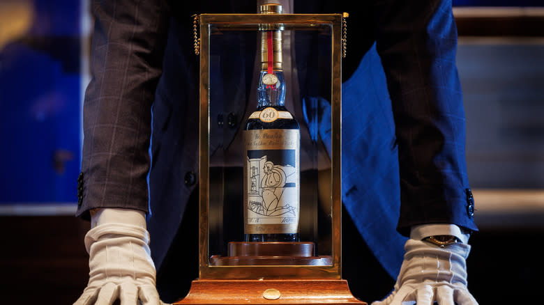 A bottle of Macallan 1926 whisky in a display case