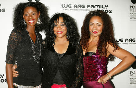 FILE PHOTO: One of the original members of the music group 'Sister Sledge' Joni Sledge (C) poses with family members, niece Camille Sledge (L) and cousin Amber Sledge (R) at the CD launch party for the 'We Are Family' CD and DVD All-Star Katrina benefit CD in Los Angeles, California August 14, 2006. REUTERS/Fred Prouser/File photo