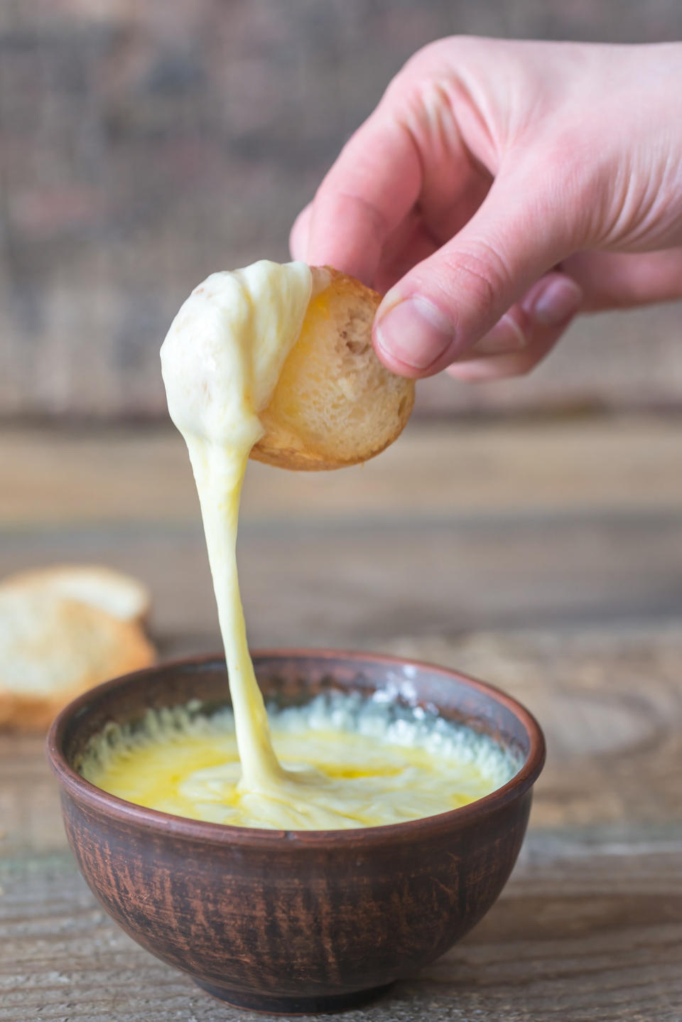 A slice of bread and cheese sauce.