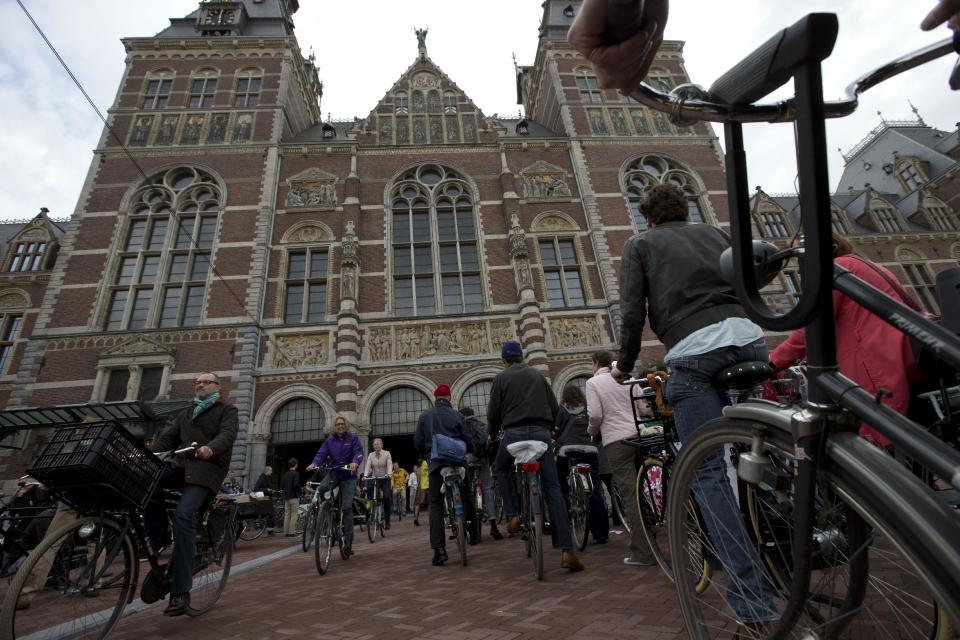 Hundreds of bicycles queue to pass through Rijksmuseum, in Amsterdam, Netherlands, Monday May 13, 2013, signaling the end of more than a decade of efforts by cyclists to ensure a passageway that runs under and through the Rijksmuseum would remain open to bike traffic. The museum, which houses masterpieces by Rembrandt van Rijn and Vincent van Gogh, among others, opened last month after a 10-year renovation. Architects and successive museum directors had opposed allowing bikes through, and a local government tried to have them barred on safety grounds. But in a city that has more bicycles than people, the bike lobby prevailed. (AP Photo/Peter Dejong)