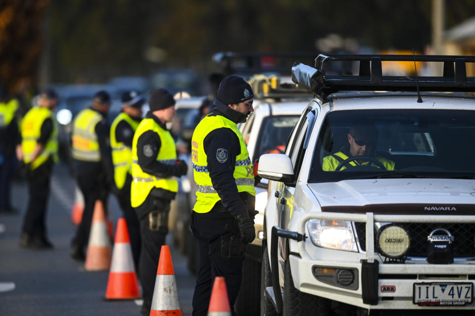 NSW Police officers check cars crossing from Victoria into New South Wales at a border check point in the NSW-Victoria border town of Albury.