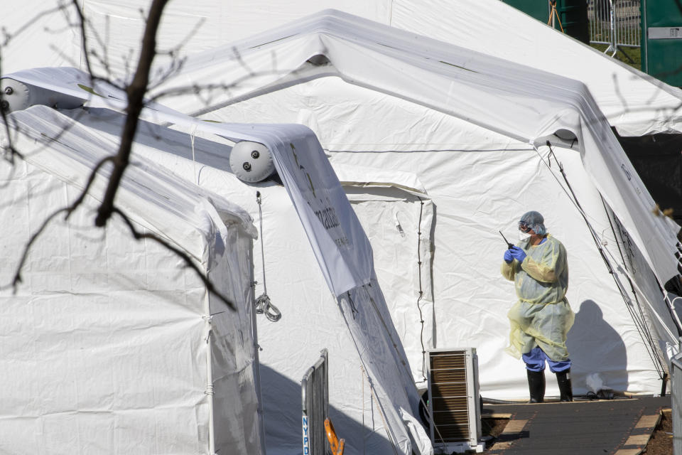 A medical personnel wears personal protective equipment while working at the Samaritan's Purse field hospital in New York's Central Park, Wednesday, April 1, 2020. The new coronavirus causes mild or moderate symptoms for most people, but for some, especially older adults and people with existing health problems, it can cause more severe illness or death. (AP Photo/Mary Altaffer)