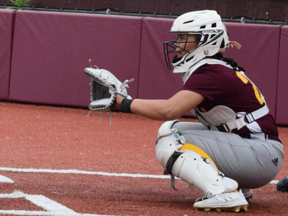 Bloomington North's Natalie Burns sets up behind the plate during the Cougars' game against Bedford North Lawrence on May 6, 2022.