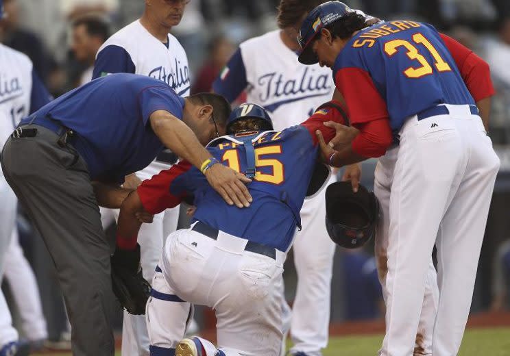 Salvador Perez is helped after being injured during a World Baseball Classic game against Italy. (AP)