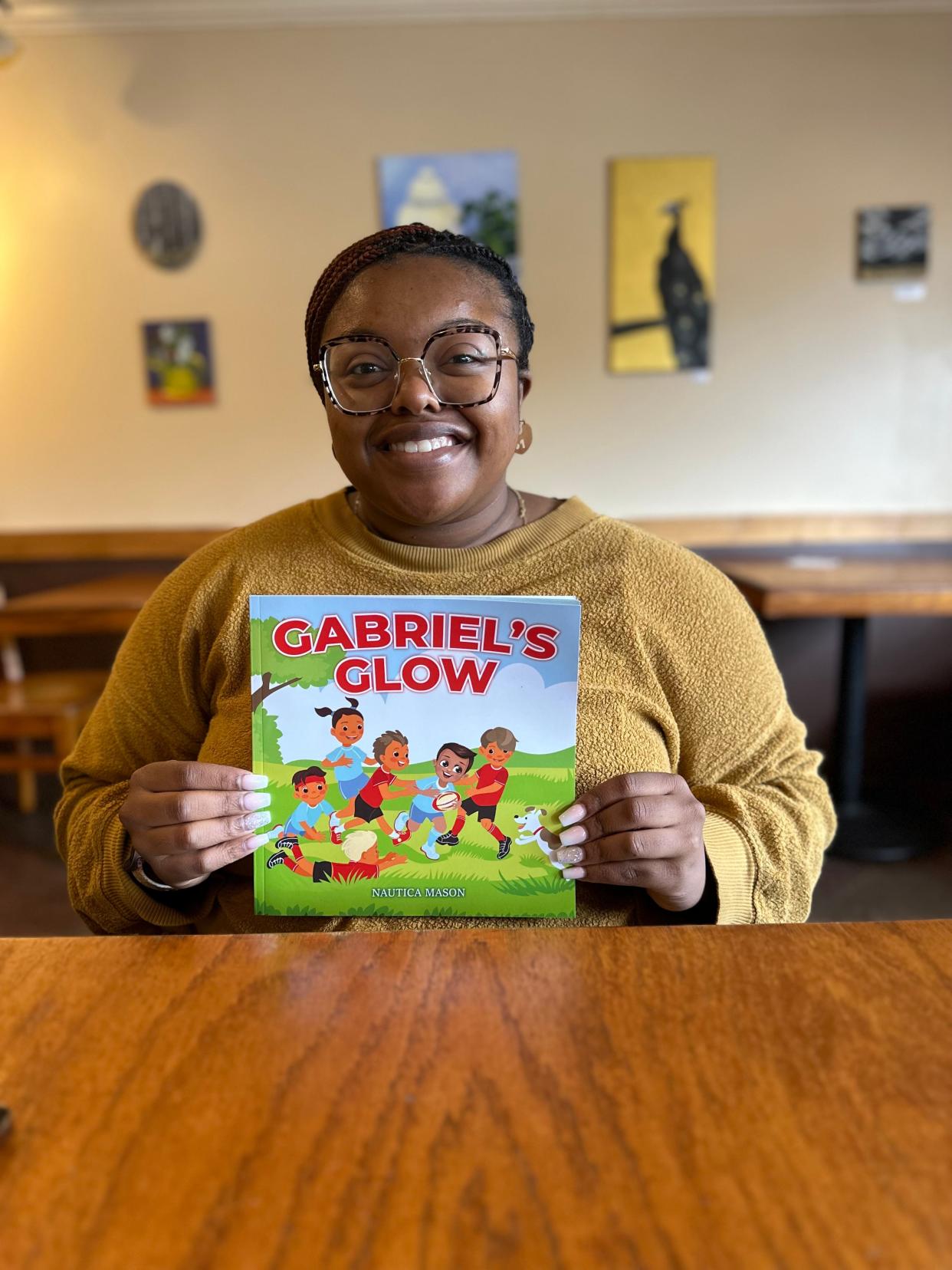 Nautica Mason shows off her book, "Gabriel's Glow" based on her son.