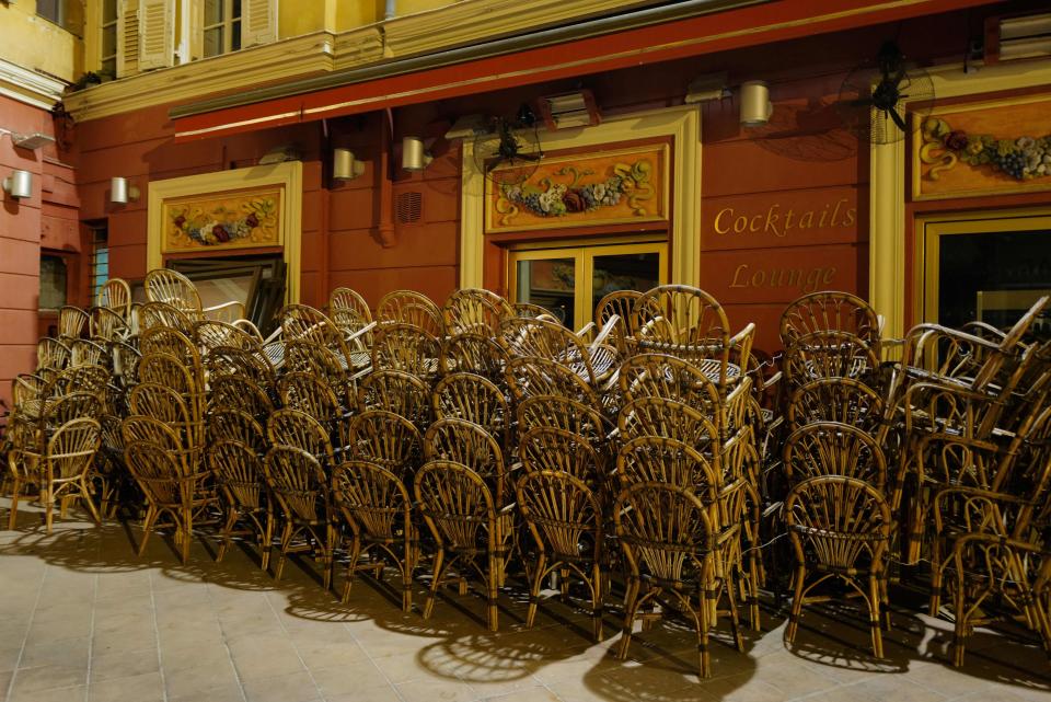 Piles of chairs outside a closed cafe in the French riviera city of Nice. / Credit: VALERY HACHE/AFP via Getty Images