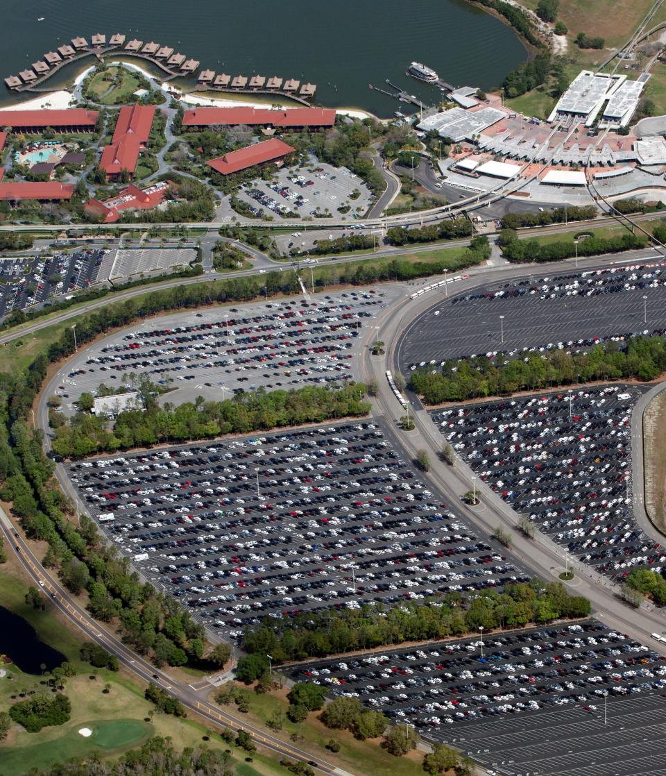 A nearly full parking lot outside the transportation hub at Disney's Magic Kingdom on the final day before closing in an effort to combat the spread of coronavirus disease (COVID-19), in an aerial view in Orlando, Florida, U.S. March 15, 2020. Picture taken March 15, 2020.  REUTERS/Gregg Newton