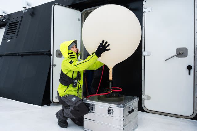 <p>Courtesy of Viking</p> Prepping a weather balloon aboard Viking Octantis in Antarctica.