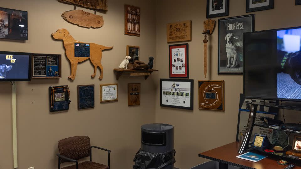 Dog memorabilia hangs on the wall of the Bureau of Alcohol, Tobacco, Firearms and Explosives National Canine Division facility in Front Royal, Virginia. - Tristen Rouse/CNN