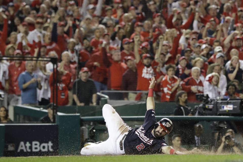 Washington Nationals' Adam Eaton scores on a hit by Anthony Rendon during the third inning of Game 3 of the baseball National League Championship Series against the St. Louis Cardinals Monday, Oct. 14, 2019, in Washington. (AP Photo/Jeff Roberson)