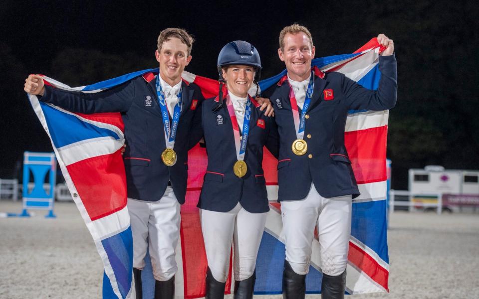 Tom McEwen, Laura Collett and Oliver Townend pose with their gold medal - PAUL GROVER FOR THE TELEGRAPH