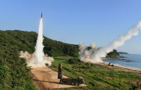 <p>South Korea’s Hyunmu-2 Missile System (L) and U.S. M270 Multiple Launch Rocket System (R) firing missiles during a U.S. and South Korea joint missile drill aimed to counter North Korea’s intercontinental ballistic missile test on July 5, 2017 in East Coast, South Korea. The U.S. Army and South Korean military responded to North Korea’s missile launch with a combined ballistic missile exercise on Wednesday, into South Korean waters along the country’s eastern coastline. (Photo: South Korean Defense Ministry via Getty Images) </p>