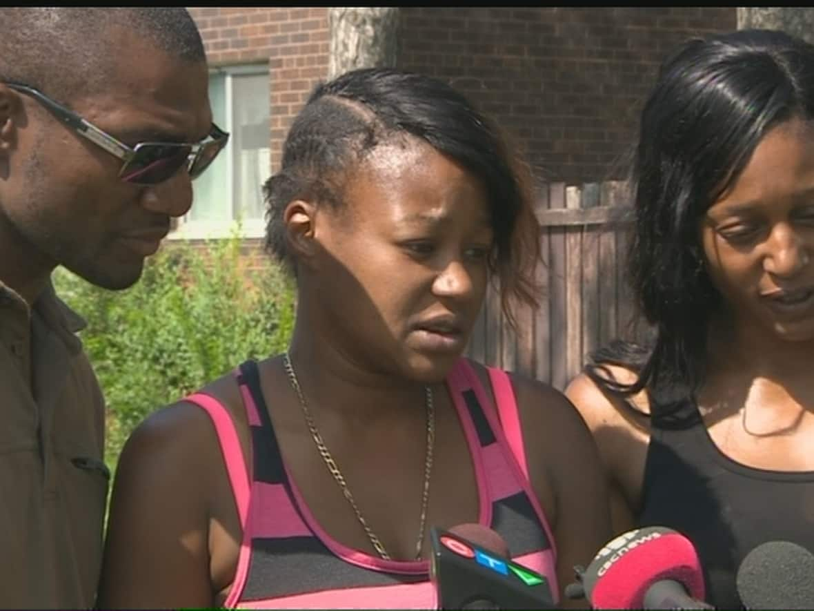  Alicia Jasquith, centre, the mother of Lecent Ross who was fatally shot at the age of 14, was distraught while speaking to the media in July of 2015. (CBC - image credit)