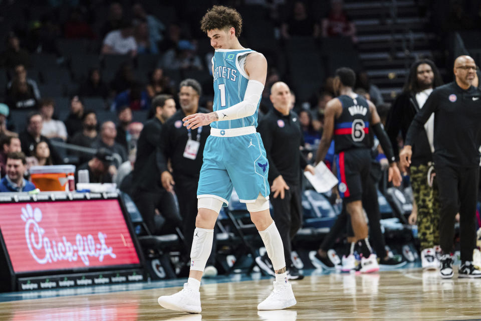 Charlotte Hornets guard LaMelo Ball walks off the court after being shaken up on a play during the second half of an NBA basketball game against the Detroit Pistons in Charlotte, N.C., Monday, Feb. 27, 2023. (AP Photo/Jacob Kupferman)