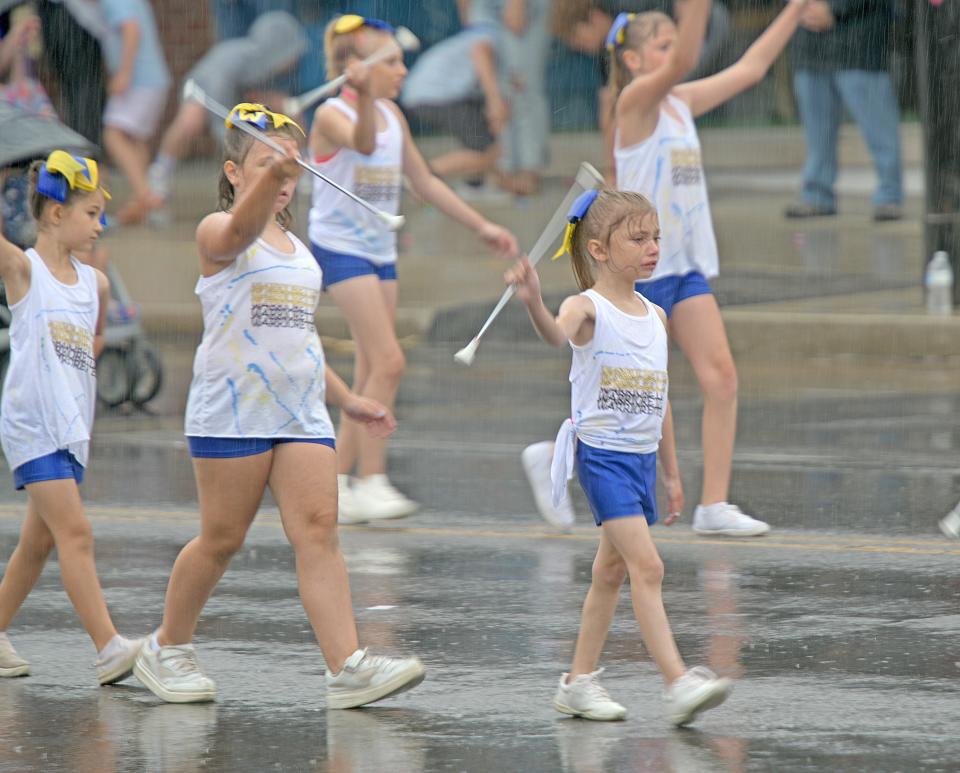 The Warriorettes try and put on a brave face as they perform for the crowds at the Miss Ohio Parade on Sunday.