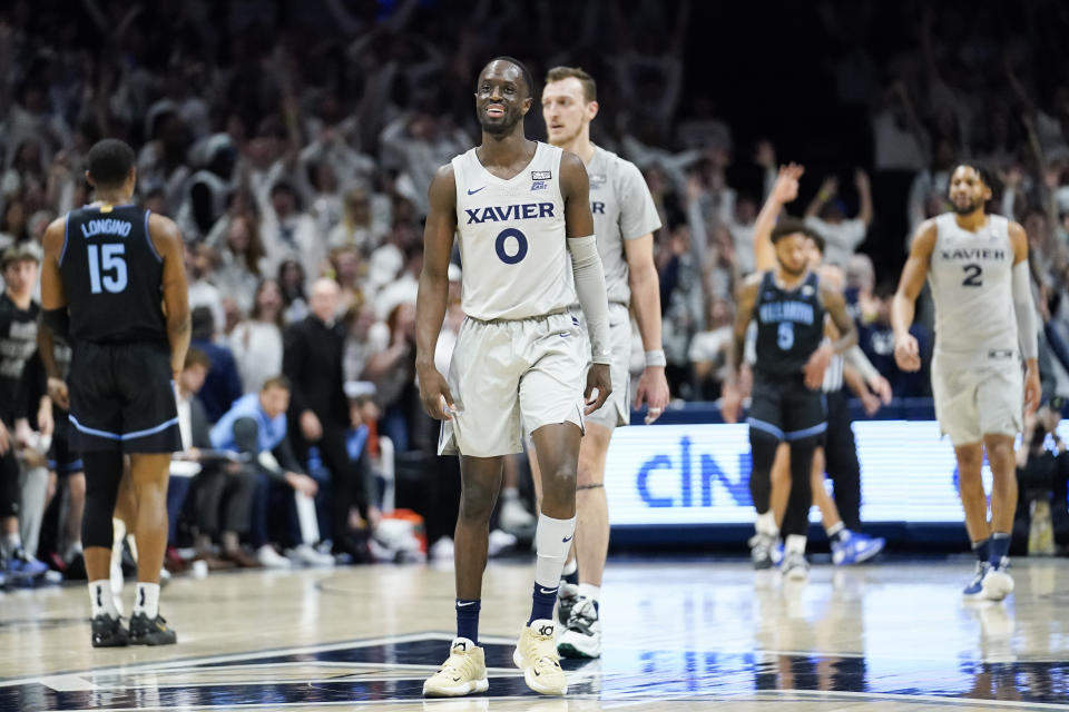 Xavier guard Souley Boum (0) reacts after hitting a 3-point shot at the buzzer during the first half of an NCAA college basketball game against Villanova, Tuesday, Feb. 21, 2023, in Cincinnati. (AP Photo/Joshua A. Bickel)