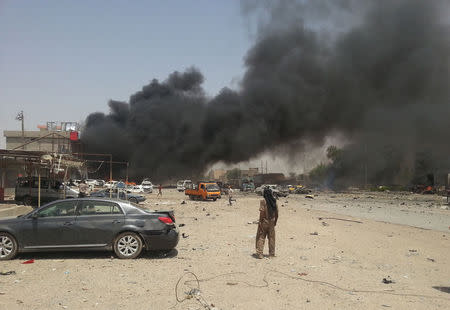 Smoke rises from the site of a car bomb attack in the town of Tuz Khurmato, north of the capital Baghdad, June 9, 2014. REUTERS/Ako Rasheed