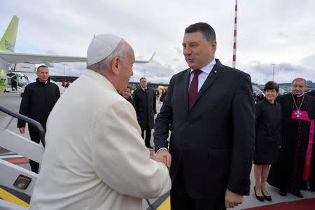 Pope Francis is welcomed by President Raimonds Vejonis at the airport in Riga, Latvia September 24, 2018. Vatican Media/Handout via REUTERS