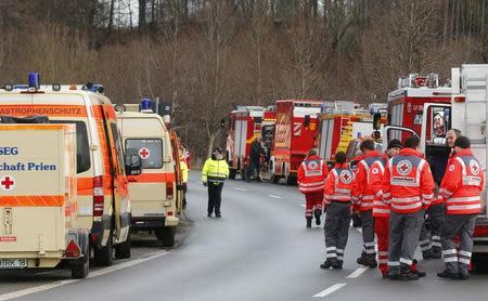 Cars of firefighters and ambulances are parked along a road near Bad Aibling in southwestern Germany, February 9, 2016. REUTERS/Michael Dalder