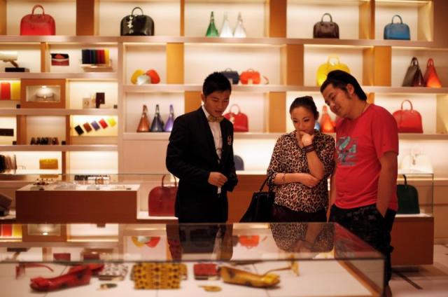 FILE--A Chinese employee looks on in a Louis Vuitton (LV) store in  Shanghai, China, 18 October 2012. More than half of all Louis Vuitton  purchases Stock Photo - Alamy