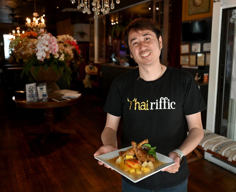 Paul Tran, owner of  Thairiffic, a Thai restaurant in downtown Marlborough, with a dish of half-duck curry, May 27, 2022.  