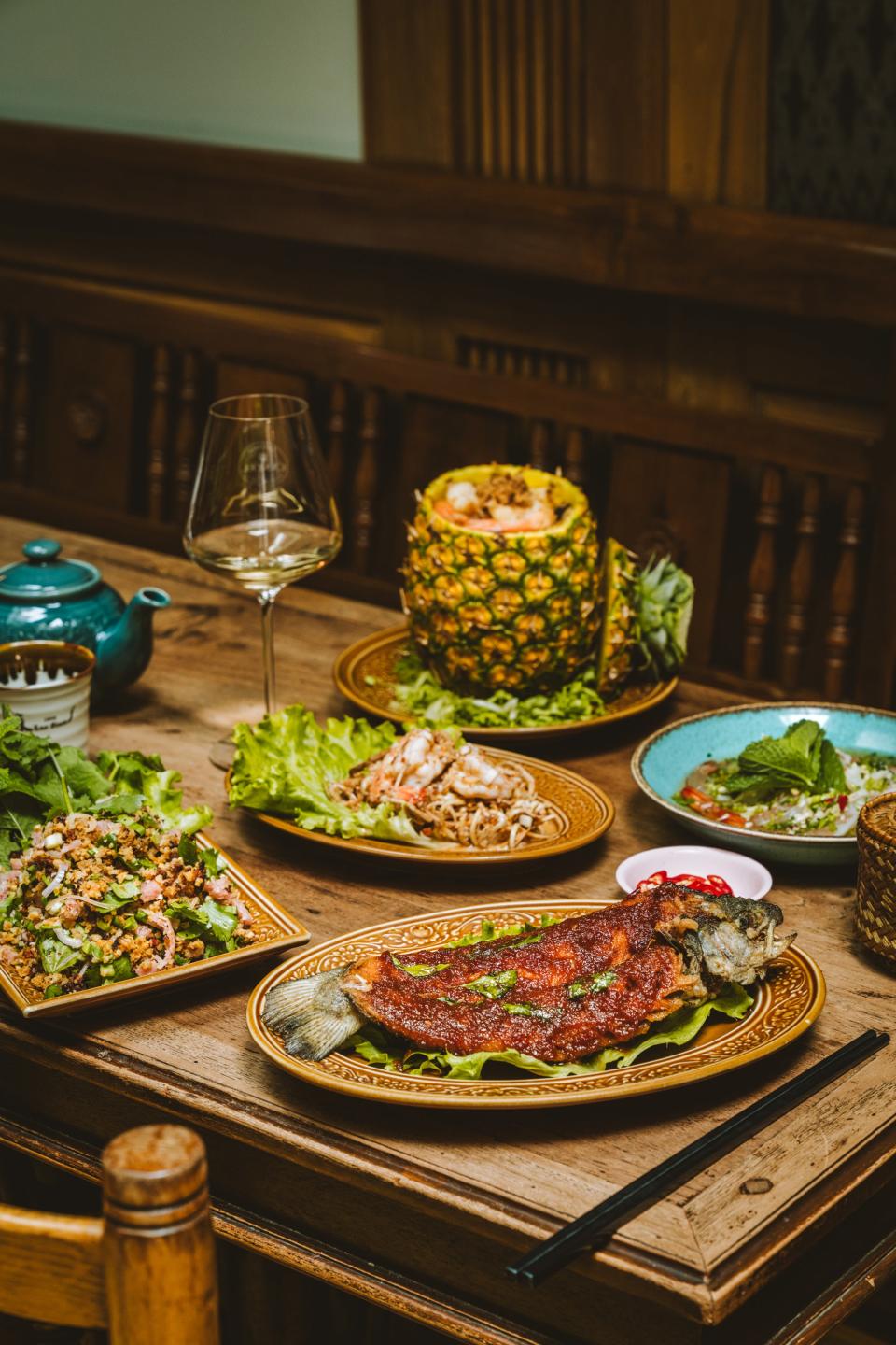 Every table at Lao Siam needs pineapple fried rice, a couple of salads, spicy shrimp, and fried trout lacquered with a tamarind sauce.