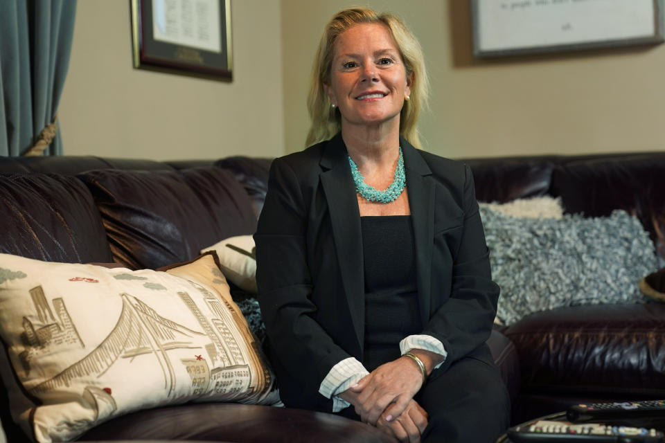 Bridget Kelly poses for a picture at her home in Ramsey, N.J., Wednesday, May 26, 2021. The pillow with the picture of the George Washington Bridge on it, left, was a gift from an aunt after her conviction in the Bridgegate scandal was overturned in the Supreme Court. (AP Photo/Seth Wenig)