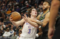 Oklahoma City Thunder guard Josh Giddey (3) goes up against Minnesota Timberwolves forward Kyle Anderson in the third quarter of an NBA basketball game Saturday, Dec. 3, 2022, in Minneapolis. (AP Photo/Bruce Kluckhohn)