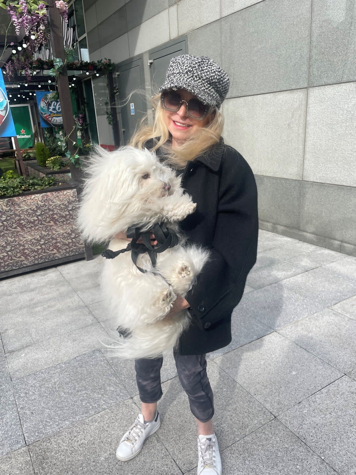 Standing outside a Waitrose and Partners store with her dog is Barbara Baldwin, who works in the stock market (The Independent)