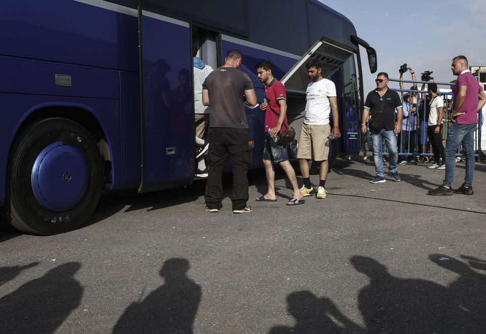 Survivors of latest tragical shipwreck board a bus to transfer to Athens at the port of Kalamata, Greece, June 16, 2023. The round-the-clock effort continued off the coast of southern Greece despite little hope of finding survivors or bodies after none have been found since Wednesday, when 78 bodies were recovered and 104 people were rescued. (John Liakos/InTime News via AP)