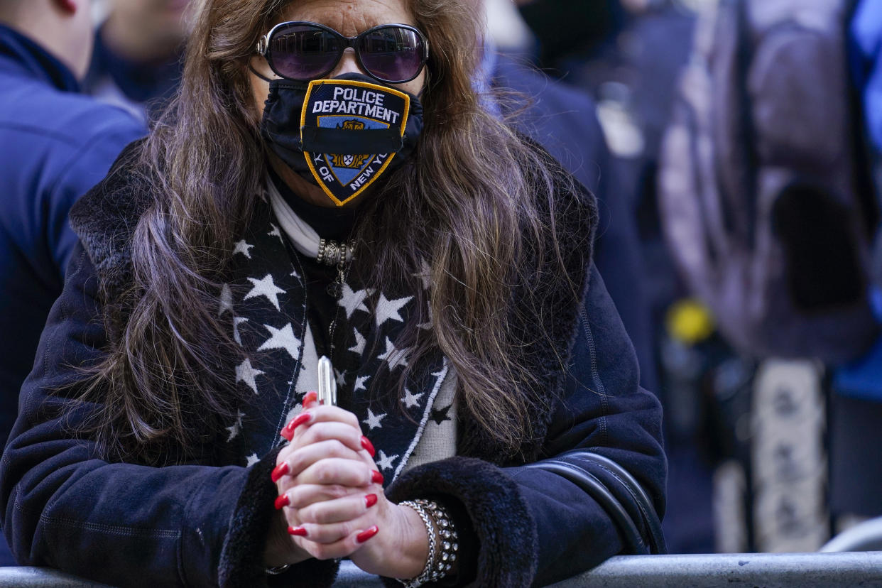 Patty Marsibiio, of the Bronx, stands in line outside St. Patricks Cathedral to pay her respects during the wake of New York City Police Officer Jason Rivera, Thursday, Jan. 27, 2022, in New York. Rivera was fatally shot Friday, Jan. 21, while answering a call about an argument between a woman and her adult son. (AP Photo/Mary Altaffer)