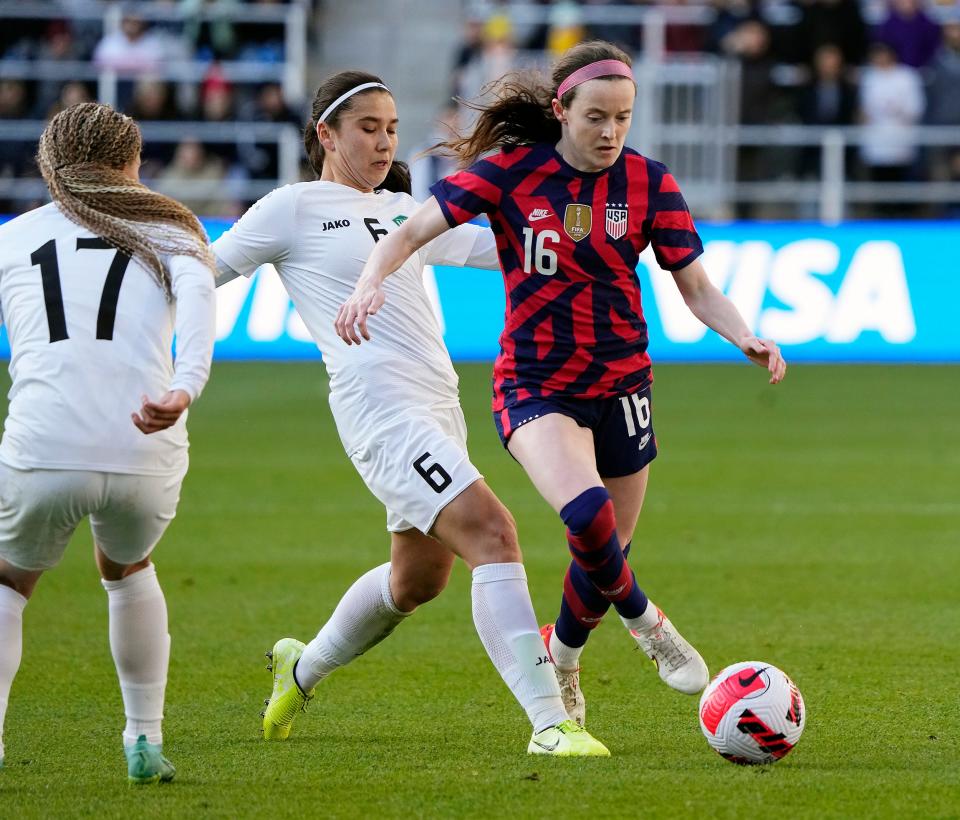 United States midfielder Rose Lavelle (16) dribbles the ball past Uzbekistan midfielder Irodahon Turdalieva (6)cduring the 1st half of their game at Lower.com Field in Columbus, Ohio on April 9, 2022. 