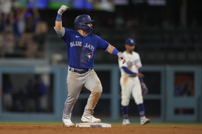 Toronto Blue Jays'  Daulton Varsho celebrates after driving in two runs with a bases-loaded double during the 11th inning of a baseball game against the Los Angeles Dodgers Monday, July 24, 2023, in Los Angeles.  (AP Photo/Marcio Jose Sanchez)