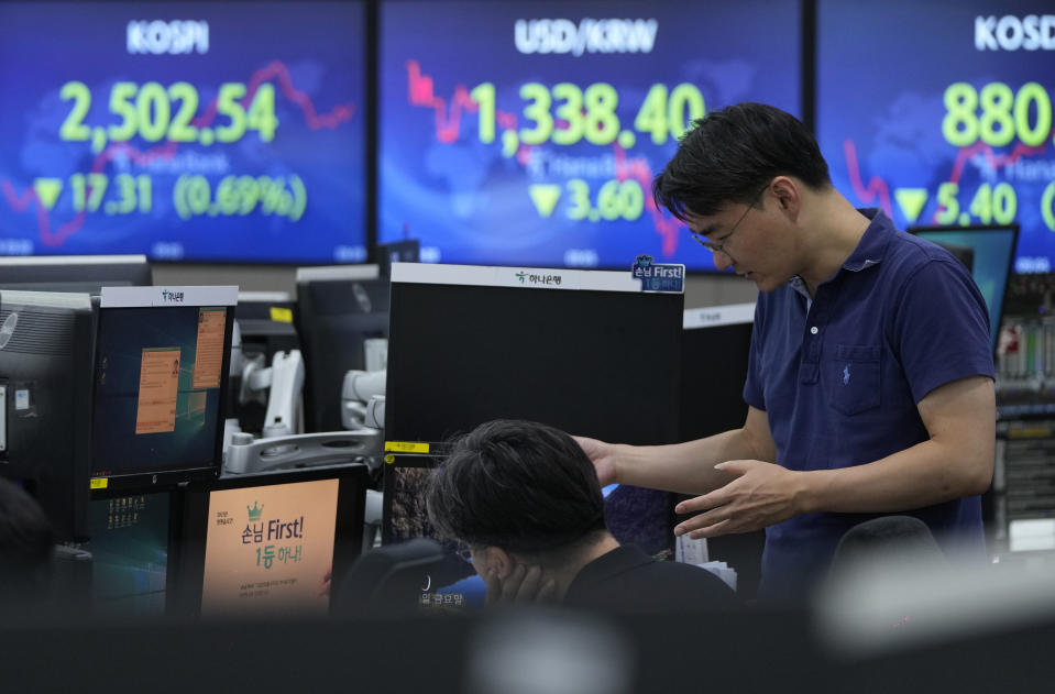 Currency traders work at the foreign exchange dealing room of the KEB Hana Bank headquarters in Seoul, South Korea, Friday, Aug. 18, 2023. (AP Photo/Ahn Young-joon)