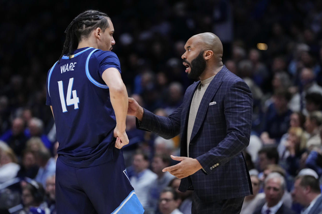 CINCINNATI, OHIO - FEBRUARY 07: Head coach Kyle Neptune of the Villanova Wildcats meets with Lance Ware #14 in the first half against the Xavier Musketeers at the Cintas Center on February 07, 2024 in Cincinnati, Ohio. (Photo by Dylan Buell/Getty Images)