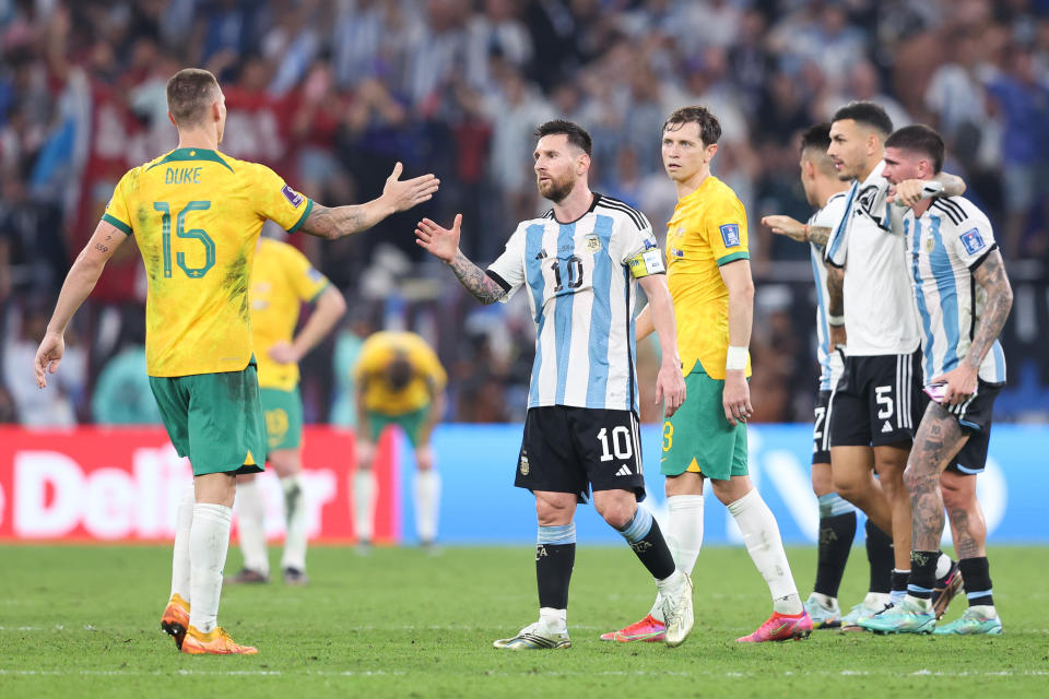 Lionel Messi (pictured middle) shakes hands with Mitchell Duke (pictured left).