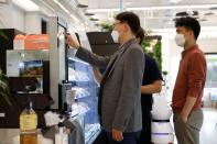 Customers place an order at a cafe where a robot that takes orders, makes coffee and brings the drinks straight to customers is being used in Daejeon