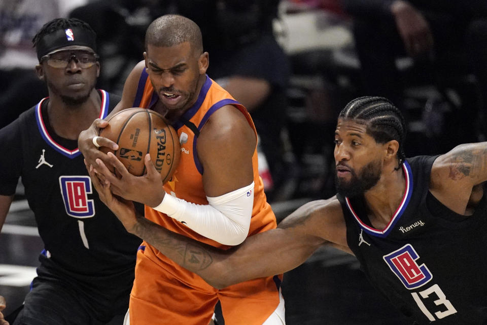 Los Angeles Clippers guard Paul George, right, reaches in on Phoenix Suns guard Chris Paul during the second half in Game 6 of the NBA basketball Western Conference Finals Wednesday, June 30, 2021, in Los Angeles. (AP Photo/Mark J. Terrill)