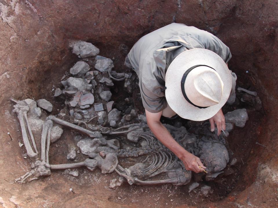 A top shot into the gravesite of the Prince of Pacopampa, where a researcher is delicately excavating remains
