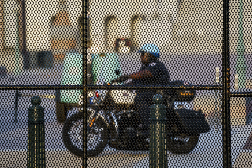 A U.S. Capitol Police officer patrols the East Plaza the morning after fencing was reinstalled around the Capitol in Washington, Thursday, Sept. 16, 2021, ahead of a planned rally by far-right supporters of former President Donald Trump who are demanding the release of rioters arrested in connection with the 6 January insurrection. (AP Photo/J. Scott Applewhite)