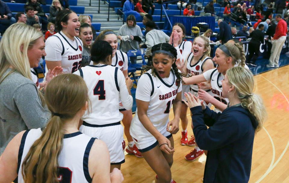 Sacred Heart celebrated after they defeated Manual 76-50 to win the Girls LIT Championship at the Valley High School gym in Louisville, Ky. on Jan. 28, 2023.  