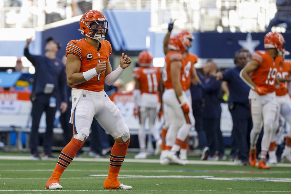 Chicago Bears' Justin Fields celebrates a touchdown during the second half of an NFL football game against the Dallas Cowboys Sunday, Oct. 30, 2022, in Arlington, Texas. (AP Photo/Ron Jenkins)