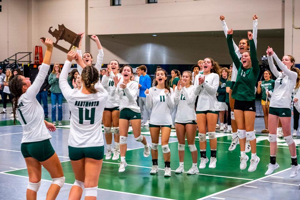 Dartmouth's Lauren Augusto, left, and Ava Crane present their team with the Div. 2 Final Four trophy.