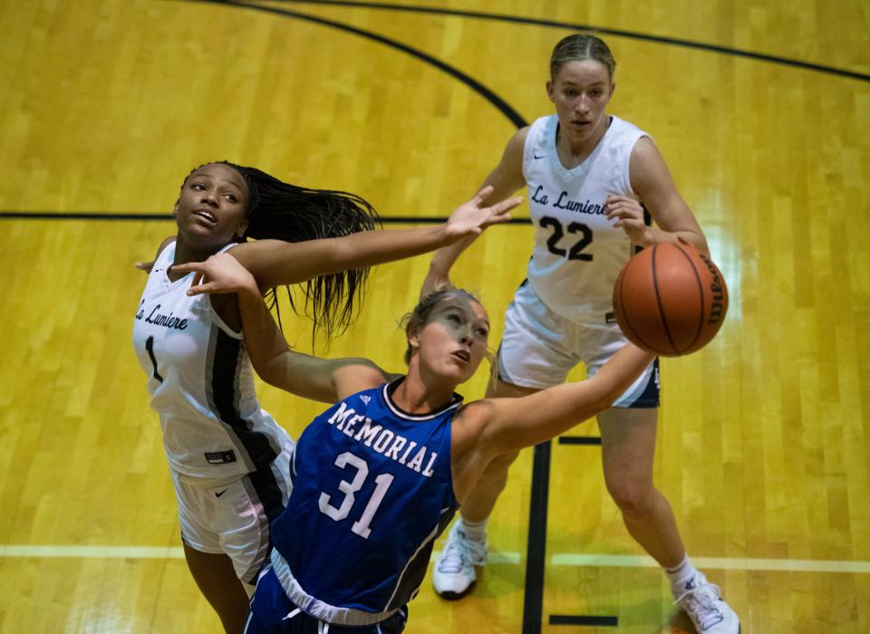 Memorial’s Emily Mattingly (31) reaches for the rebound as the Memorial Tigers play the La Lumiere Lakers during the 2022 Evansville North Showcase at North High School in Evansville, Ind., Friday, Dec. 2, 2022. 