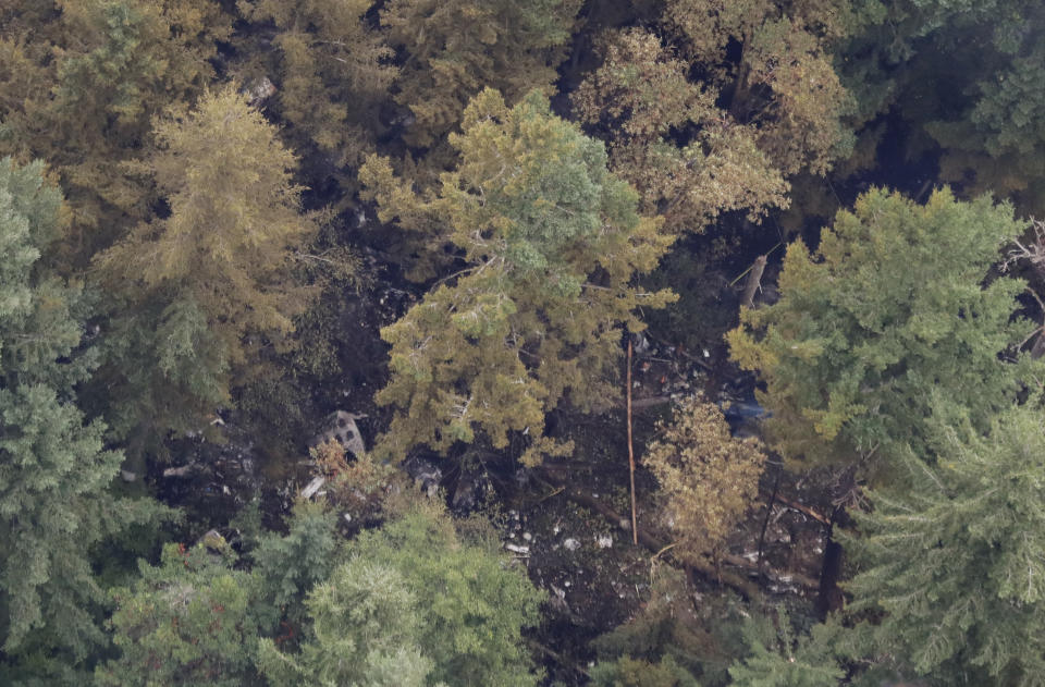 The site on Ketron Island in Washington state where an empty Horizon Air turboprop plane crashed Friday after it was stolen from Sea-Tac International Airport is seen from the air, Saturday, Aug. 11, 2018, near Steilacoom, Wash. Investigators were working to find out how an airline employee stole the plane and crashed it after being chased by military jets that were quickly scrambled to intercept the aircraft. (AP Photo/Ted S. Warren)