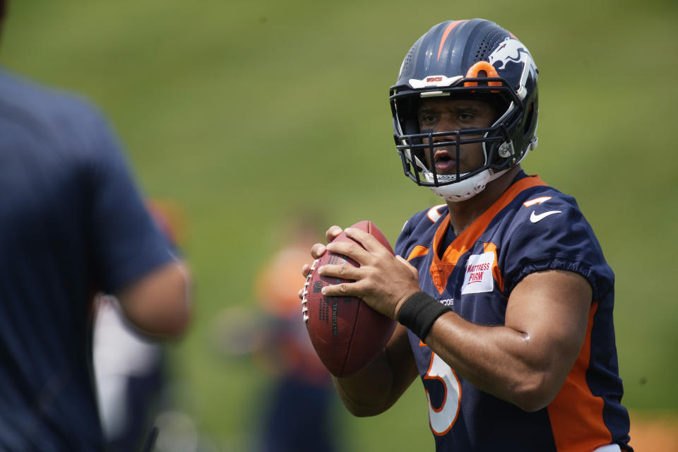 Denver Broncos quarterback Russell Wilson takes part in drills during the NFL team's practice at the Broncos' headquarters Monday, June 13, 2022, in Centennial, Colo. (AP Photo/David Zalubowski)