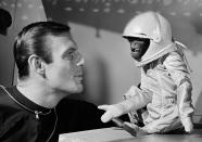 <p>His own space suit, with oxygen tank, doesn’t make Barney the monkey any happier as he and actor Adam West view the situation in their space capsule in Hollywood on Jan. 24, 1964. Barney, a South American woolly monkey, is blasted into space with West, as an astronaut, in a new movie, “Robinson Crusoe On Mars.” ( Photo: AP) </p>