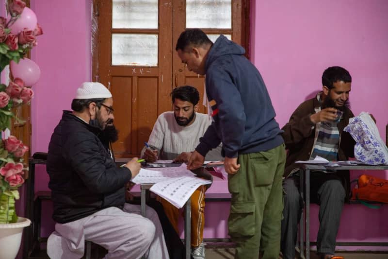 A man checks his name on a voting list inside a polling station during the first phase of the lower house, of the Indian parliamentary elections. Faisal Bashir/SOPA Images via ZUMA Press Wire/dpa